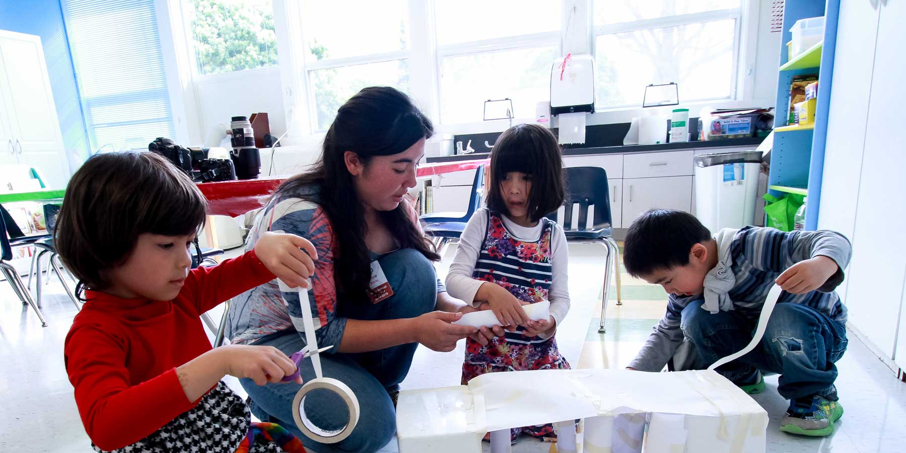 children creating with boxes and tape